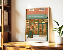 Lade das Bild in den Galerie-Viewer, Kunstdruck mit detailreicher Illustration eines Bücherladens in warmen Farben und Spruch "books can take you anywhere"