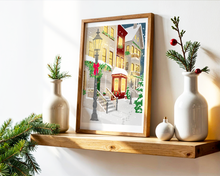 Lade das Bild in den Galerie-Viewer, Weihnachtsdekoration mit festlichem Poster Kunstdruck und Tannengrün. Das Poster zeigt eine Kleinstadt im Winter mit schneiten Gehwehgen und Weihnachtsdekoration und vermittelt gemütliche festliche Atmosphäre