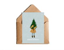 Lade das Bild in den Galerie-Viewer, Weihnachtskarte wundervolle Weihnachten mit Illustration einer Tanne tragenden Frau auf blauen Hintergrund im Schneegestöber