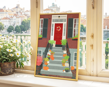 Lade das Bild in den Galerie-Viewer, Gerahmtes Poster auf einem Fensterbrett. Das Poster zeigt einen herbstlich geschmückten Hauseingang mit vielen Details in Herbstfarben: herbstlicher Kranz an der roten Haustür, Gummistiefel, Kürbisse und verschiedene Pflanzen schmücken die Treppen vor dem Haus.
