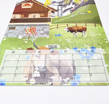 Lade das Bild in den Galerie-Viewer, Wandkalender 2027 mit integriertem praktischem Monatsplaner. Zu sehen ist eine Nahaufnahme des Februar Kalenderblatts. Es zeigt eine detailreich illustrierte Naturlandschaft in der Schweiz mit Kühen. Das Kalendarium mit Platz für die wichtigsten Termine und Notizenim unteren Drittel des Kalenders ist im Fokus.
